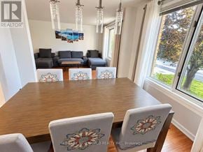 Quinte West (Trenton Ward) apartment for rent - A dining room with a wooden table and chairs with floral designs.