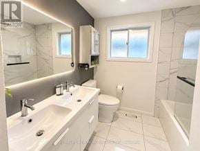 Quinte West (Trenton Ward) apartment for rent - A white bathroom with marble tiles and a large mirror.