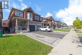 Brampton (Bram East) apartment for rent - A white car is parked in front of a house with a sign that says "REALTOR".