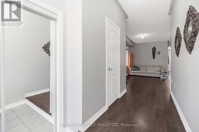 Brampton (Bram East) apartment for rent - A hallway with a white door and a brown floor.