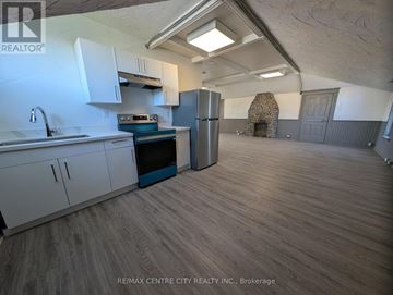 London East (East K) multi-family for rent - A kitchen with a refrigerator, oven, and sink.