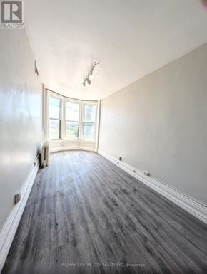 London East (East K) multi-family for rent - A room with a wooden floor and a large window.