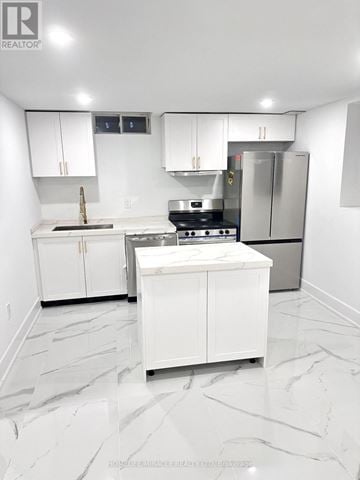 Whitby (Williamsburg) apartment for rent - A white kitchen with a marble floor and a refrigerator in the corner.