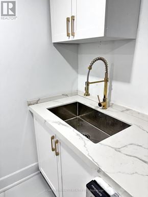Whitby (Williamsburg) apartment for rent - A white sink with a gold faucet in a white kitchen.
