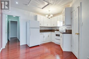 Toronto (Caledonia-Fairbank) apartment for rent - A kitchen with white cabinets and a refrigerator.