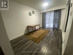 Brampton (Heart Lake West) apartment for rent - A room with wooden flooring and a table with two chairs.