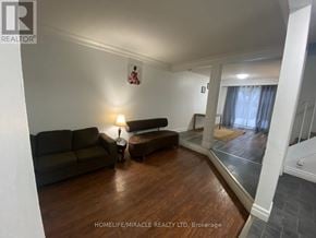 Brampton (Heart Lake West) apartment for rent - A living room with a brown couch and a lamp.