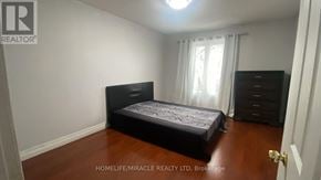 Brampton (Heart Lake West) apartment for rent - A bedroom with a bed, dresser, and nightstand.