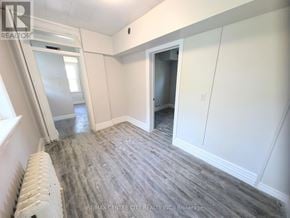 London East (East K) multi-family for rent - A room with a grey carpet and white walls.