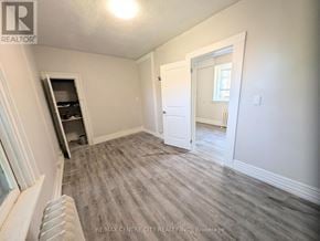 London East (East K) multi-family for rent - A room with a door and a window with a view of a hallway.