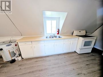 London East (East K) multi-family for rent - A kitchen with white cabinets and a white oven.