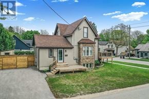 Collingwood duplex for rent - A house with a brown roof and a wooden fence is for sale.