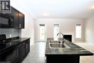 Hamilton townhouse for rent - A kitchen with black cabinets and a black countertop.