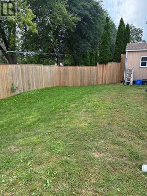 Niagara Falls (Cherrywood) apartment for rent - A backyard with a wooden fence and a shed.