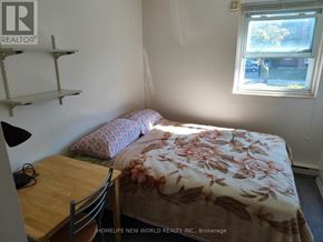 Windsor condo for rent - A bedroom with a bed, desk, and chair.