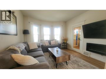 Vancouver apartment for rent - A living room with a grey couch and a coffee table.