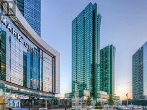 Toronto (Lansing-Westgate) condo for rent - A view of a city street with a large glass building on the left and a tall glass building on the right.