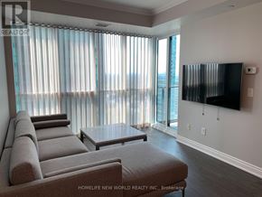 Toronto (Lansing-Westgate) condo for rent - A living room with a large couch, a flat screen TV, and a coffee table.