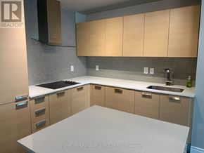 Toronto (Lansing-Westgate) condo for rent - A kitchen with a white counter top and wooden cabinets.