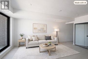 Toronto (Junction Area) condo for rent - A modern living room with a white sofa, a wooden coffee table, and a large painting on the wall.