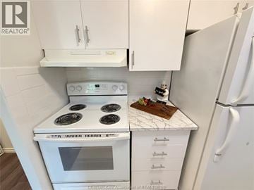 Chatham condo for rent - A white kitchen with a stove and a refrigerator.