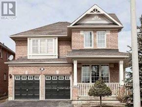 Mississauga (East Credit) apartment for rent - A house with a brick facade and a large front yard.