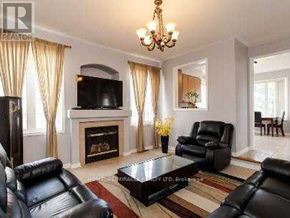 Mississauga (East Credit) apartment for rent - A living room with a fireplace, leather chairs, and a chandelier.