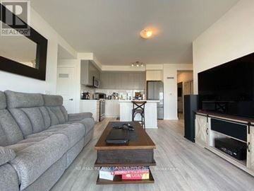 Mississauga (Central Erin Mills) condo for rent - A modern living room with a grey sofa and a coffee table.