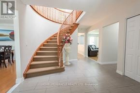 Hamilton (Riverdale) apartment for rent - A spacious hallway with a staircase and a white door.