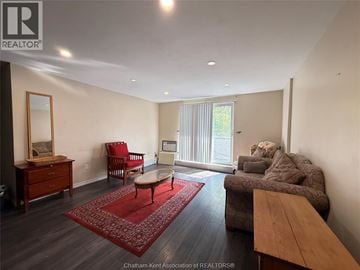 Chatham condo for rent - A living room with a red rug and a brown couch.