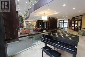 Toronto (Willowdale East) condo for rent - A piano in a showroom with a glass barrier.