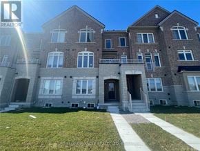 Brampton (Heart Lake West) townhouse for rent - A large brick building with a well-maintained lawn in front.