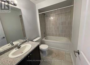Brampton (Heart Lake West) townhouse for rent - A bathroom with a sink, toilet, and bathtub.
