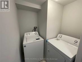 Brampton (Heart Lake West) townhouse for rent - A small laundry room with a washer and dryer.