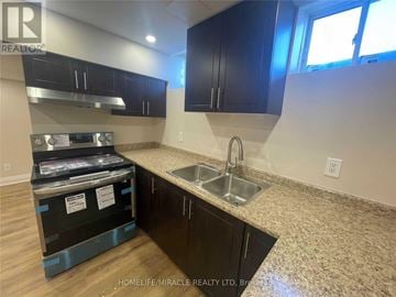 Brampton (Heart Lake West) townhouse for rent - A kitchen with black cabinets and a granite countertop is under construction.