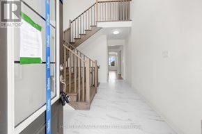 Adjala-Tosorontio (Colgan) apartment for rent - A hallway with a staircase and a sign that says "HOMELIFE/MIRACLE REALTY LTD. Brokerage".