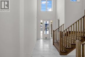 Adjala-Tosorontio (Colgan) apartment for rent - A hallway with a staircase and a door leading to a balcony.