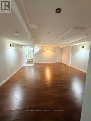 Mississauga (Meadowvale Village) townhouse for rent - A spacious room with wooden floors and white walls.