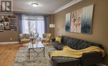 Kitchener apartment for rent - A living room with a black couch and a glass coffee table.