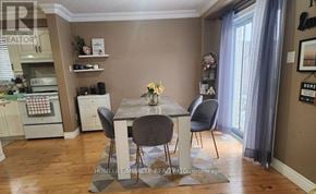 Kitchener apartment for rent - A dining room with a table set for two and a kitchen area in the background.