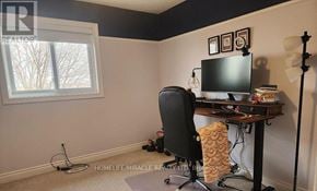 Kitchener apartment for rent - A room with a desk, chair, and a window.