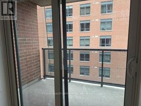 Toronto (Junction Area) condo for rent - A balcony with a glass door leading to a brick building.