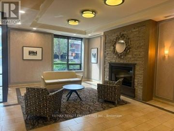 Toronto (Junction Area) condo for rent - A living room with a fireplace and a couch.