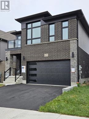 Waterloo apartment for rent - A modern house with a black garage door is for sale.