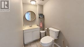 Toronto (Weston-Pellam Park) apartment for rent - A bathroom with a toilet, sink, and mirror.