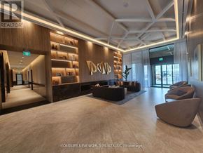 Vaughan (Vaughan Corporate Centre) condo for rent - A spacious lobby with a reception desk and seating area.