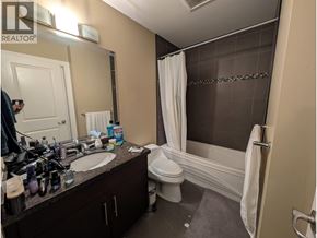 Richmond apartment for rent - A bathroom with a white toilet, sink, and bathtub.