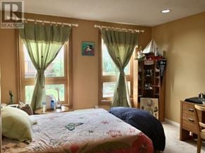 Toronto (Bayview Village) apartment for rent - A bedroom with a bed, a desk, and a window with green curtains.