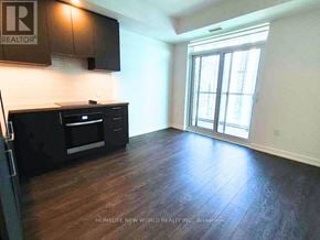 Vaughan (Vaughan Corporate Centre) condo for rent - A kitchen with dark wood floors and white walls.