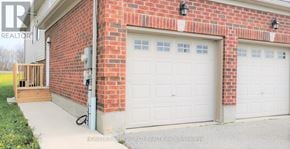 Barrie (Georgian Drive) apartment for rent - A red brick house with two white garage doors.